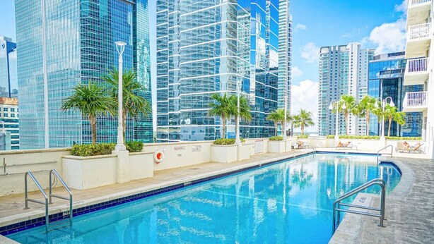 Piscina ao ar livre com vista para edifícios modernos.