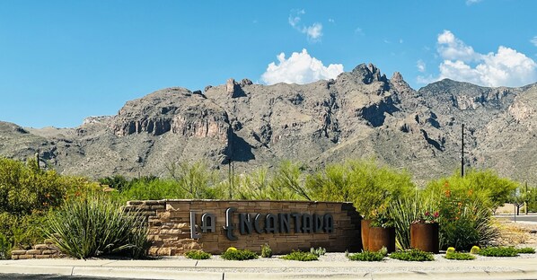 A sign with "LA ENCANTADA" in front of a mountainous landscape. - Quiet desert getaway with beautiful views and heated pool, pet-friendly (Tucson)