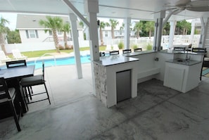 Outdoor dining - Enjoy luxury in this 5BR, 5BA home with private pool in Sunset Beach, NC. (Sunset Beach)