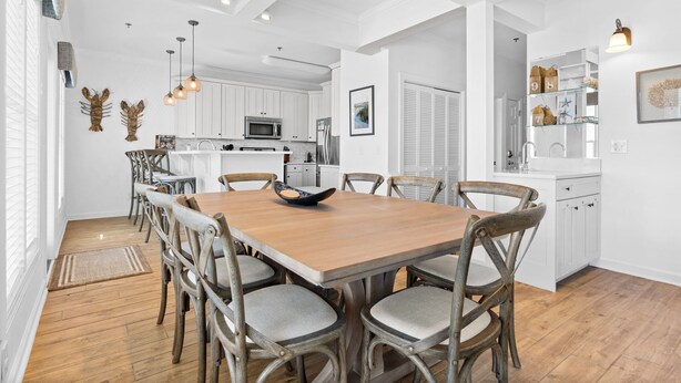 A spacious kitchen with white cabinetry, a central island, and pendant lighting. - CottageVacations4u "The Great Escape"-ocean view villa-pool club-direct beach access (Ocean Isle Beach)