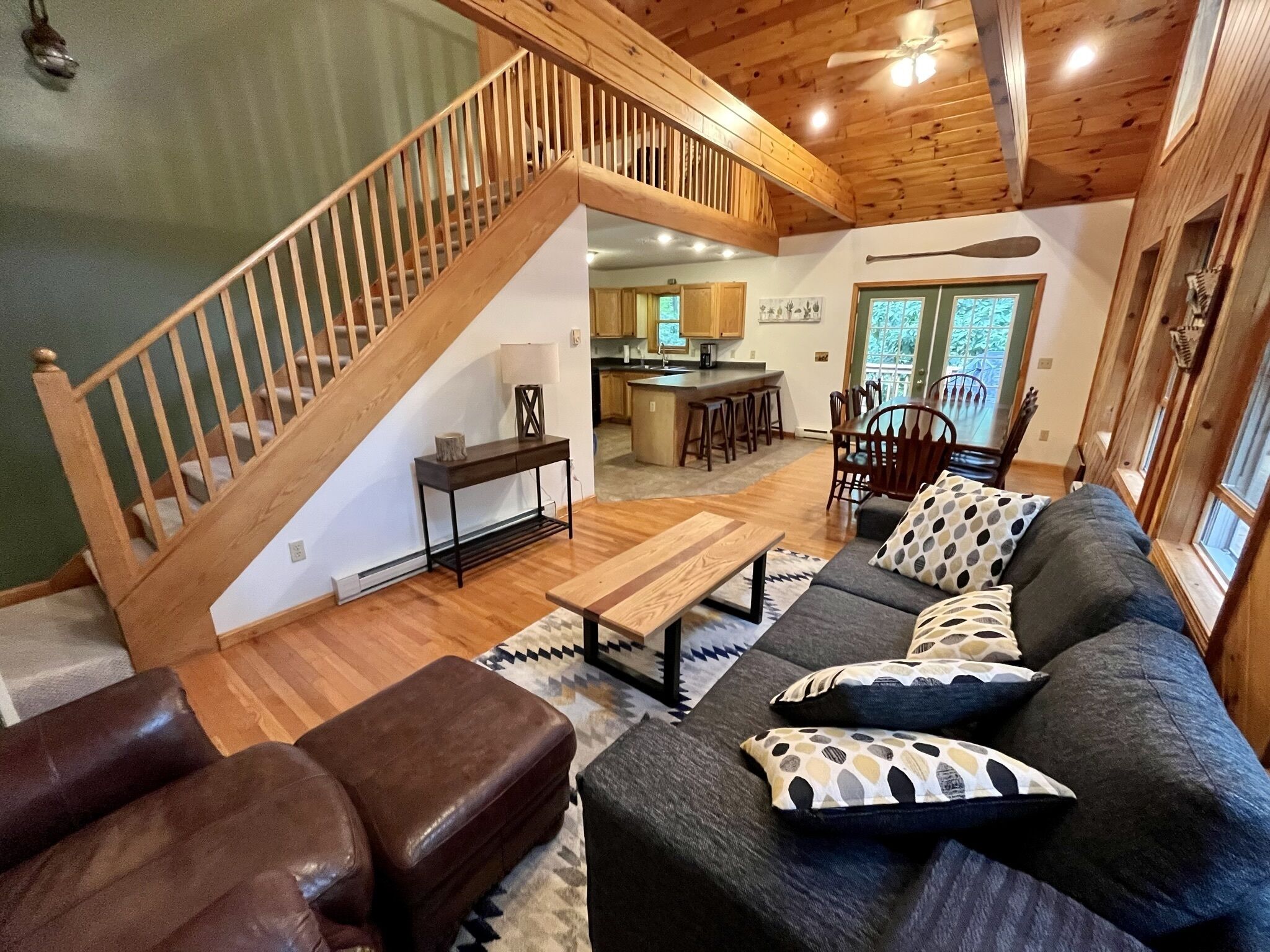 Main floor living room with deep comfy couch and large leather lounging chair.
