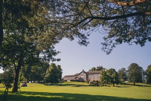 A large, historic building with a symmetrical facade, surrounded by a well-maintained lawn and mature trees. - Edenmore Golf and Country Club (Craigavon)