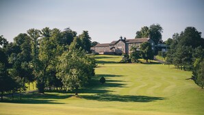 A golf course with a clubhouse and trees. - Edenmore Golf and Country Club (Craigavon)