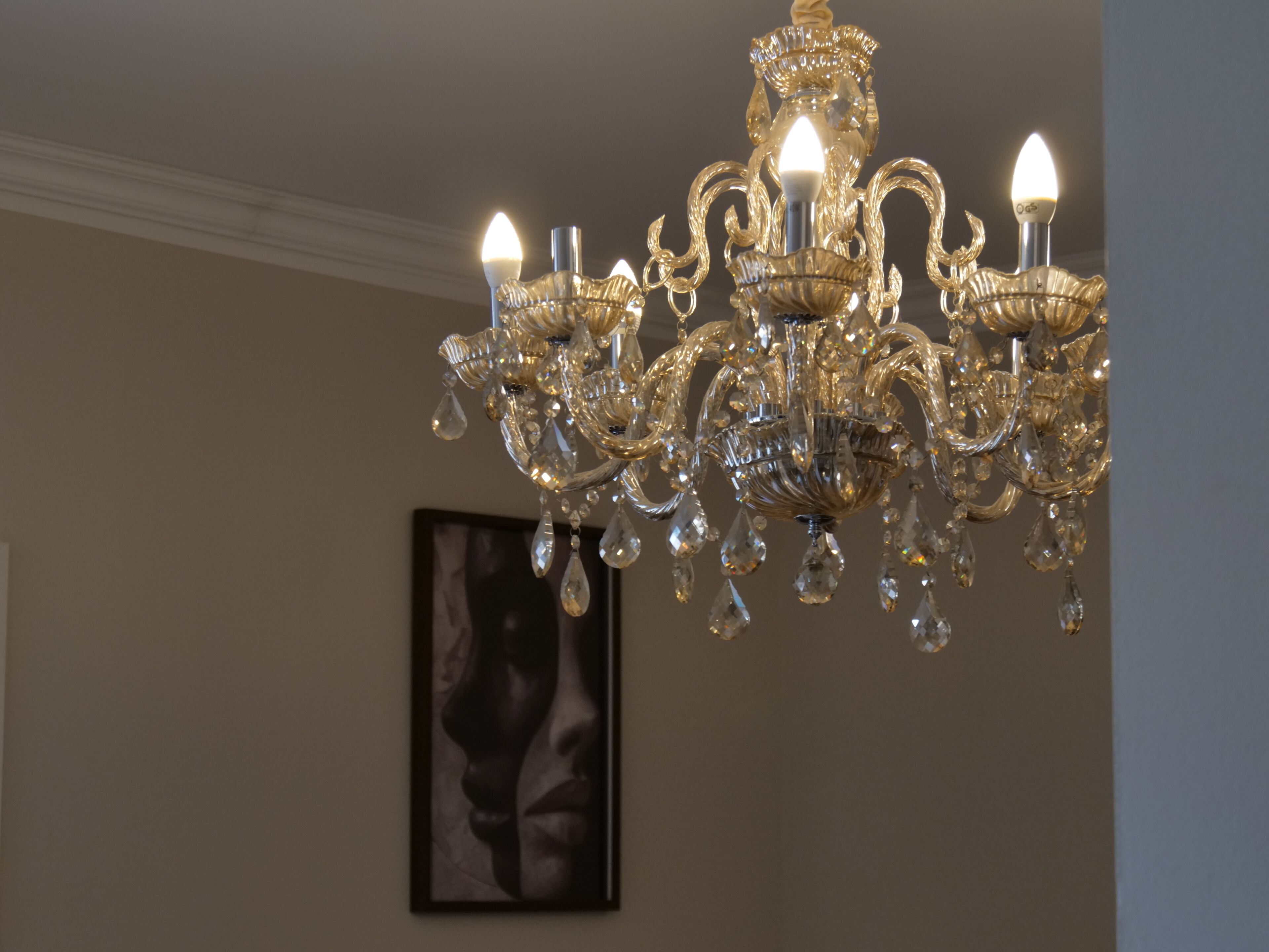 A chandelier with multiple light fixtures and crystal decorations.