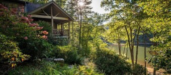 Lake front with private dock, fire pit, hammock, pool table & gorgeous views! Fishing poles, paddle boards & canoe provided.