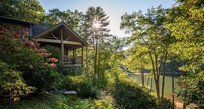 Lake front with private dock, fire pit, hammock, pool table & gorgeous views! Fishing poles, paddle boards & canoe provided.
