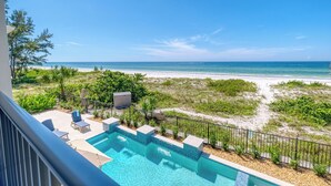 A pool area with a view of the beach and ocean. - I'm Already There - 6 Bedroom Direct Gulf and Intracoastal with Heated Pool (Indian Shores)