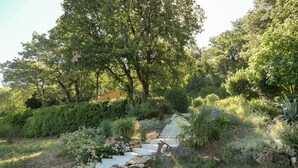 A stone staircase surrounded by lush greenery and trees.