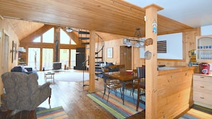 A spacious cabin with a large dining area, a cozy living room, and a kitchen. - Seventh Heaven - Heavenly Retreat (Great Cacapon)