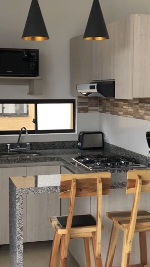 Fridge, microwave, stovetop, coffee/tea maker