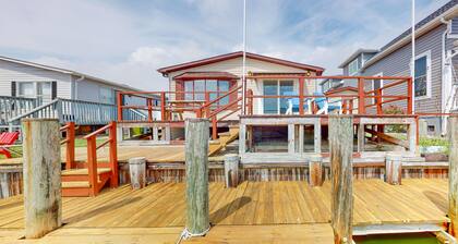 Renovated waterfront home with dock, bay access, & shared pool/tennis