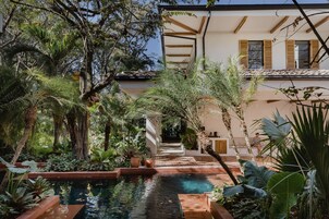 Una piscina al aire libre, sillones reclinables de piscina