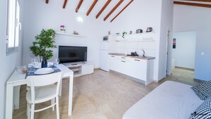 A compact living space with a kitchenette, a dining area, and a bedroom. - One bedroom apartment with terrace. (TAHICHE)