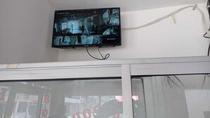 A flat-screen TV mounted on a wall with a cable connected to it. - HOSTAL MIRADOR (Coca)