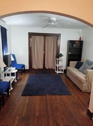 Relax in this inviting living space with a sofa, armchair, and reading nook.