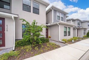 Stylish townhouses with front yards and uniform architecture.