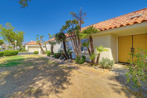 A residential area with a row of houses, each with a red-tiled roof and a yellow door. - Furnished Patio + Pool Access: Palm Desert Home! (Palm Desert)