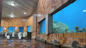 Relax by the tranquil pool, surrounded by soothing water features and a view of the outdoors.