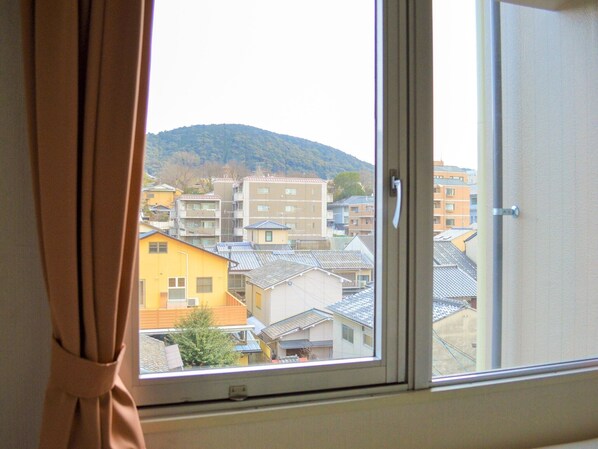 Enjoy a peaceful view of the surrounding residential area from the room's large window.