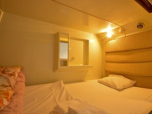 Enjoy a restful stay in this simply designed room with a neatly made bed and a compact layout.