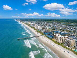 An aerial view of a coastal city with a long beach, a pier, and residential buildings. - Oceanfront 1BR • Top-Floor Balcony Views • Cherry Grove • Sea Cabin 304-A (North Myrtle Beach)
