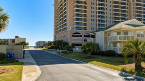 A multi-story hotel with balconies, a parking area, and a well-maintained lawn. - Closest Shorehaven Unit to Cherry Grove Beach • 4-Min Walk • Sleeps 6 (North Myrtle Beach)