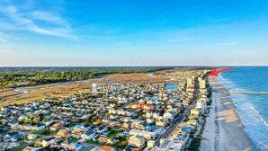 An aerial view of a coastal town with houses, a beach, and a river. - Corner Oceanfront 2BR – Elevated Balcony Views - Cherry Grove - Beachmaster 107 (North Myrtle Beach)