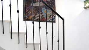 A staircase with black metal railings and white steps. - Typical Andalusian house in the heart of the historic center (Almuñécar)
