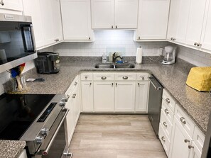 Fridge, microwave, coffee/tea maker, cookware/dishes/utensils