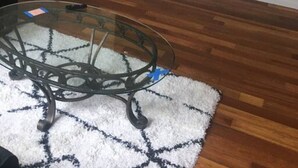 A room with a glass table, a white door, and a mounted flat-screen TV. - The couples home with free wifi (Schenectady)