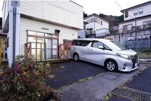 Traditional Japanese-style house with a sliding door and small porch area.