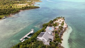 An aerial view of a coastal property with a large house, a dock, and a swimming pool. - Waterfront 4-Bedroom Home on Private Peninsula w/ Private Dock! (Elbow Cay)