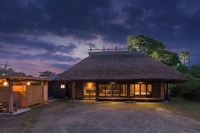 Chigi Terrace A traditional thatched roof house  / Koyu-gun Miyazaki