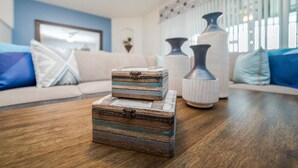 A wooden chest with a vintage design on a wooden table in a living room with a sofa and decorative vases. - New Listing! Solterra Resort, 7mi to Disney & 17mi to Universal - GRH438841 (Davenport)