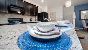 A kitchen with dark cabinets, a white countertop, and a sink. - New Listing! Solterra Resort, 7mi to Disney & 17mi to Universal - GRH438841 (Davenport)