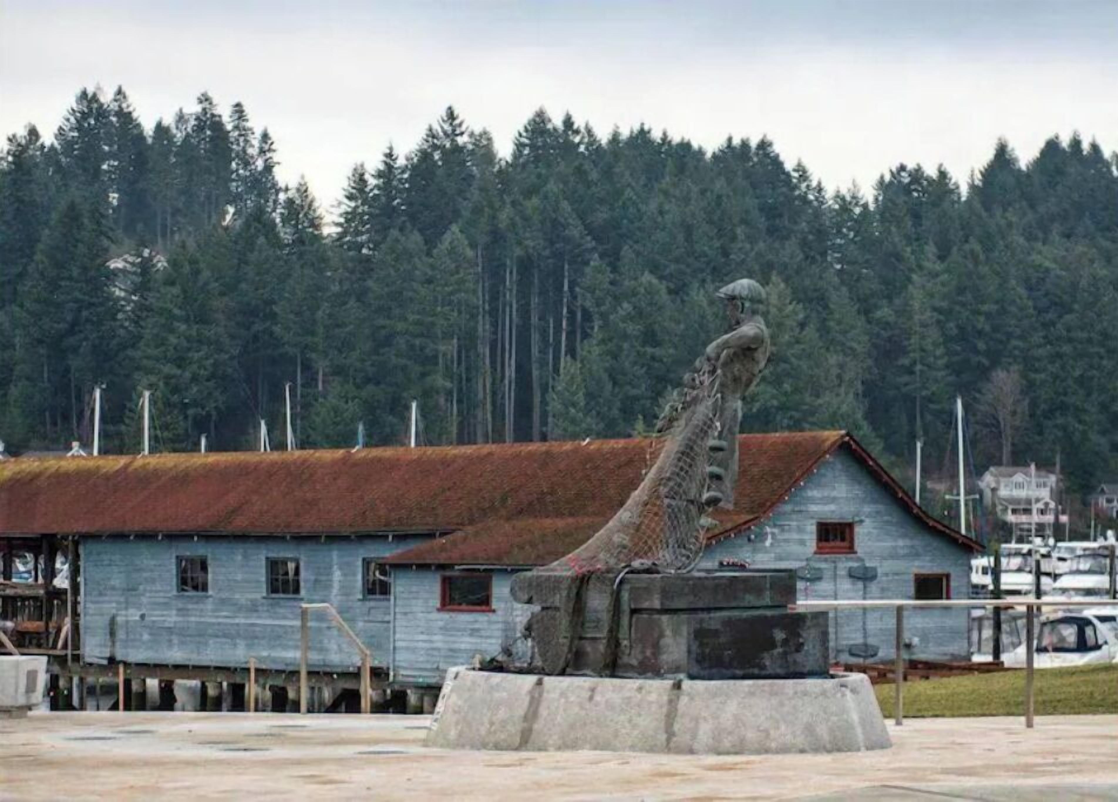 A rustic building with a metal sculpture in front.