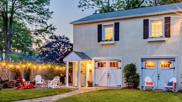 A two-story house with a covered patio, a garage, and a well-maintained lawn. - Gorgeous Carriage House close to USNA, walk to stadium, free parking,  pets+kids (Annapolis)