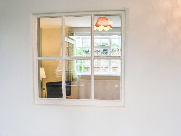 A window with a view of a staircase and a radiator.