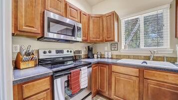 Microwave, dishwasher, coffee/tea maker, dining tables