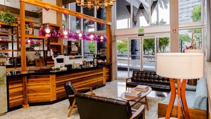 A modern interior with a wooden counter, leather seating, and large windows.