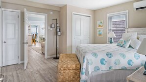 A bedroom with a bed, bedside table, lamp, and a bench. - Coastal Condo Close to Beach & Entertainment (Rehoboth Beach)
