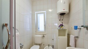 A small, clean bathroom with a toilet, bidet, and sink. - Gorgeous apartment in Kanica with WiFi (Kanica)
