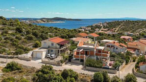 A coastal village with terracotta-roofed houses, a clear blue sea, and a hilly landscape. - Gorgeous apartment in Kanica with WiFi (Kanica)