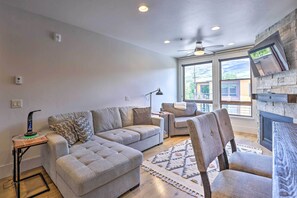 Relax in this inviting living room with a large sofa, armchairs, and a side table.