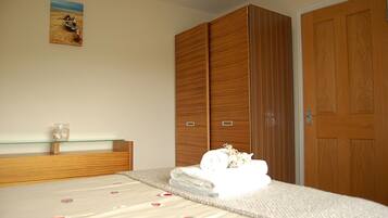 Relax in a serene bedroom with a large bed and ample storage space.