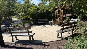 An outdoor seating area with benches and a wooden structure. - Entire 3 bedrooms/2 bathrooms fence yard, near Costco, Sam's (Gaithersburg)