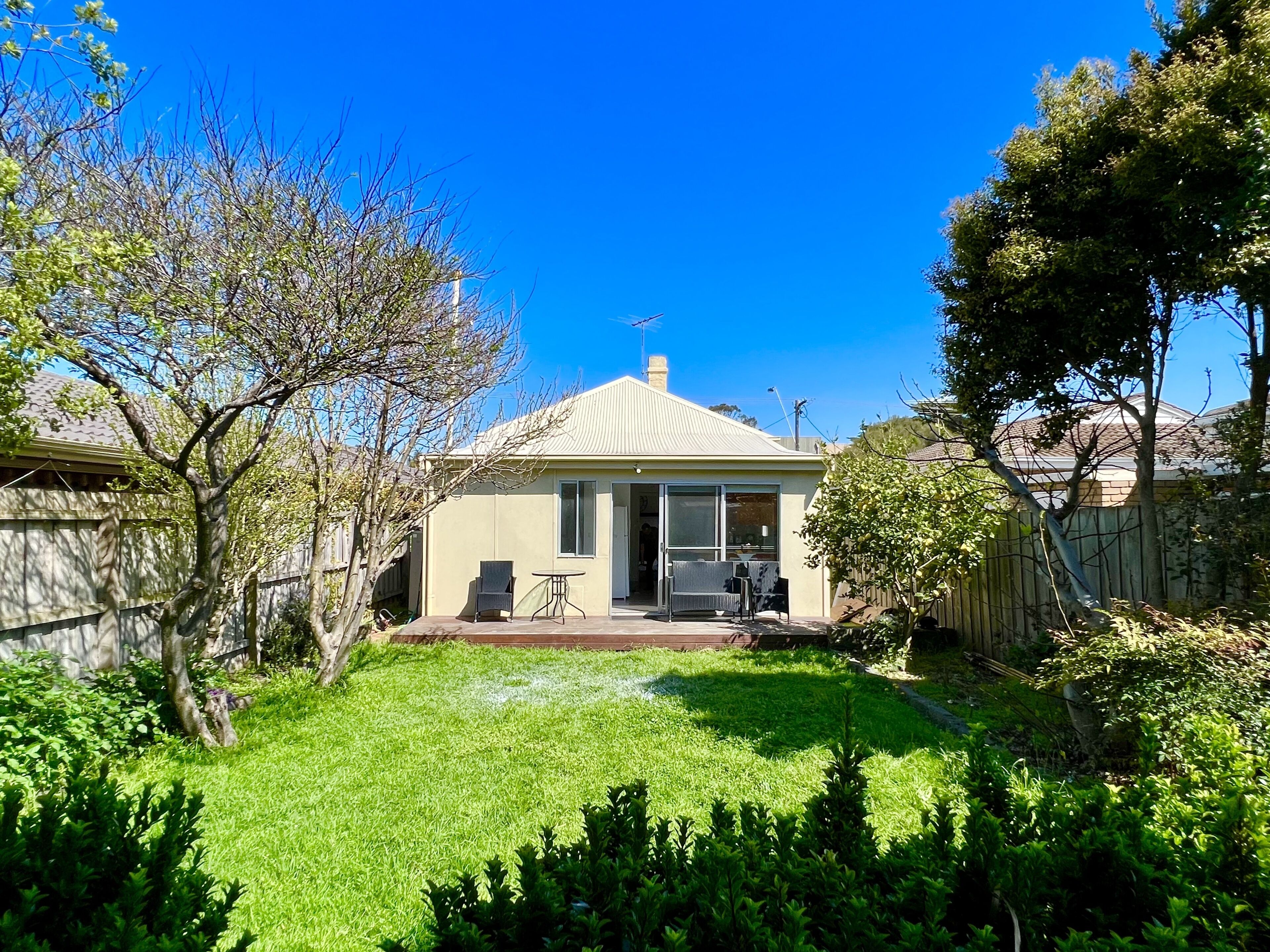 Large enclosed backyard with patio