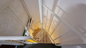 Una escalera con barandales blancos y una barandilla de madera.