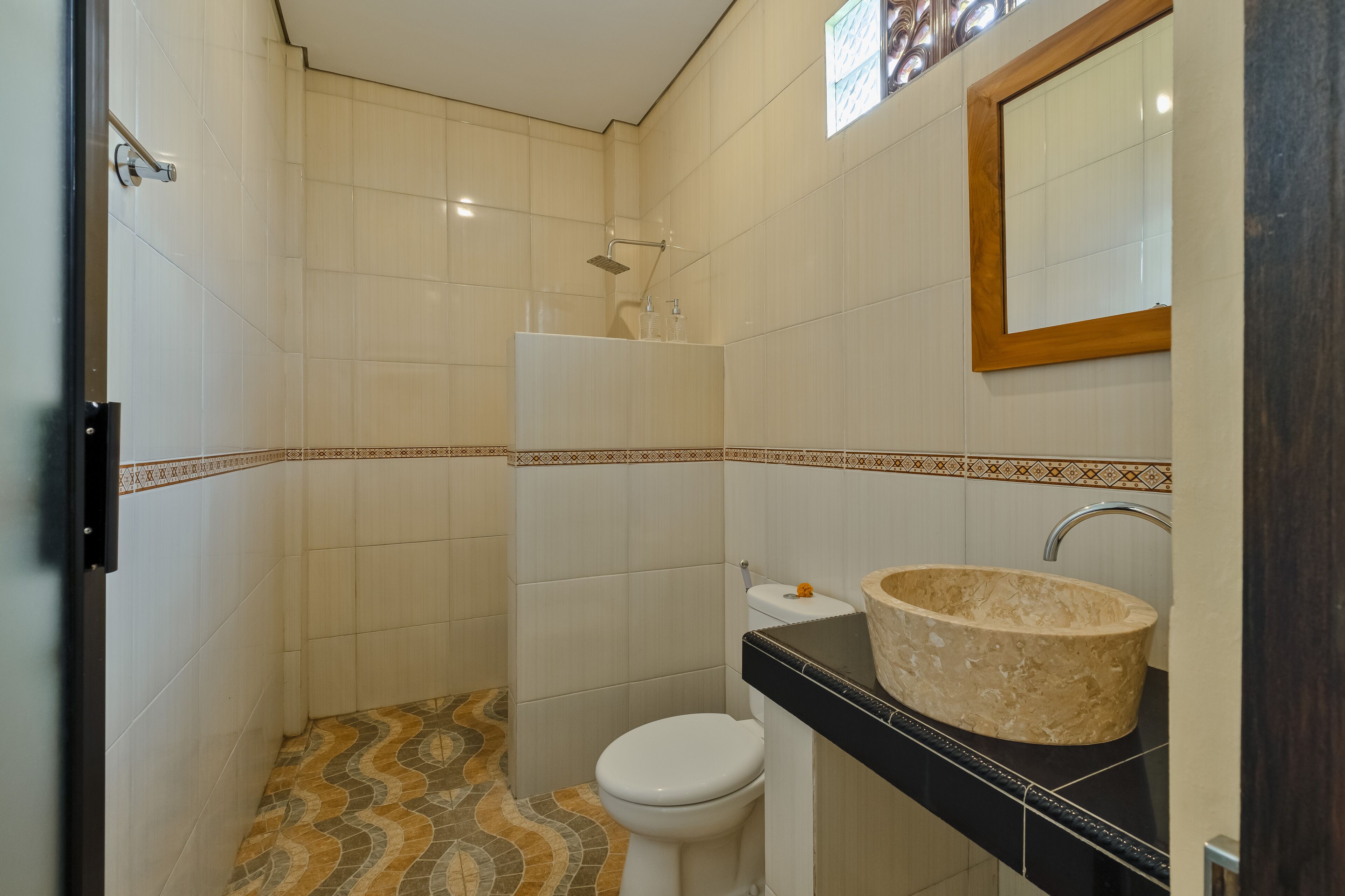 A bathroom with a toilet, sink, and shower.