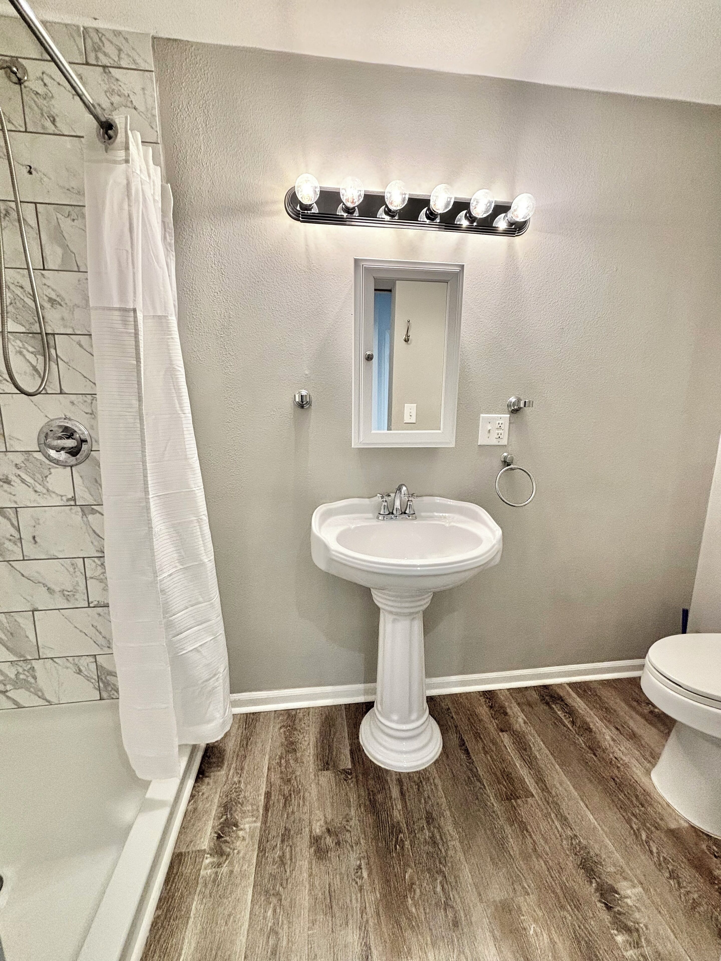 Shower, hair dryer, towels, toilet paper